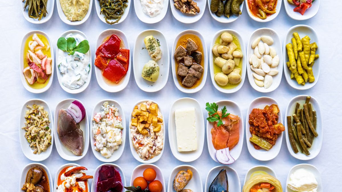 A vibrant display of traditional Turkish meze dishes on a white tablecloth, showcasing authentic flavors.